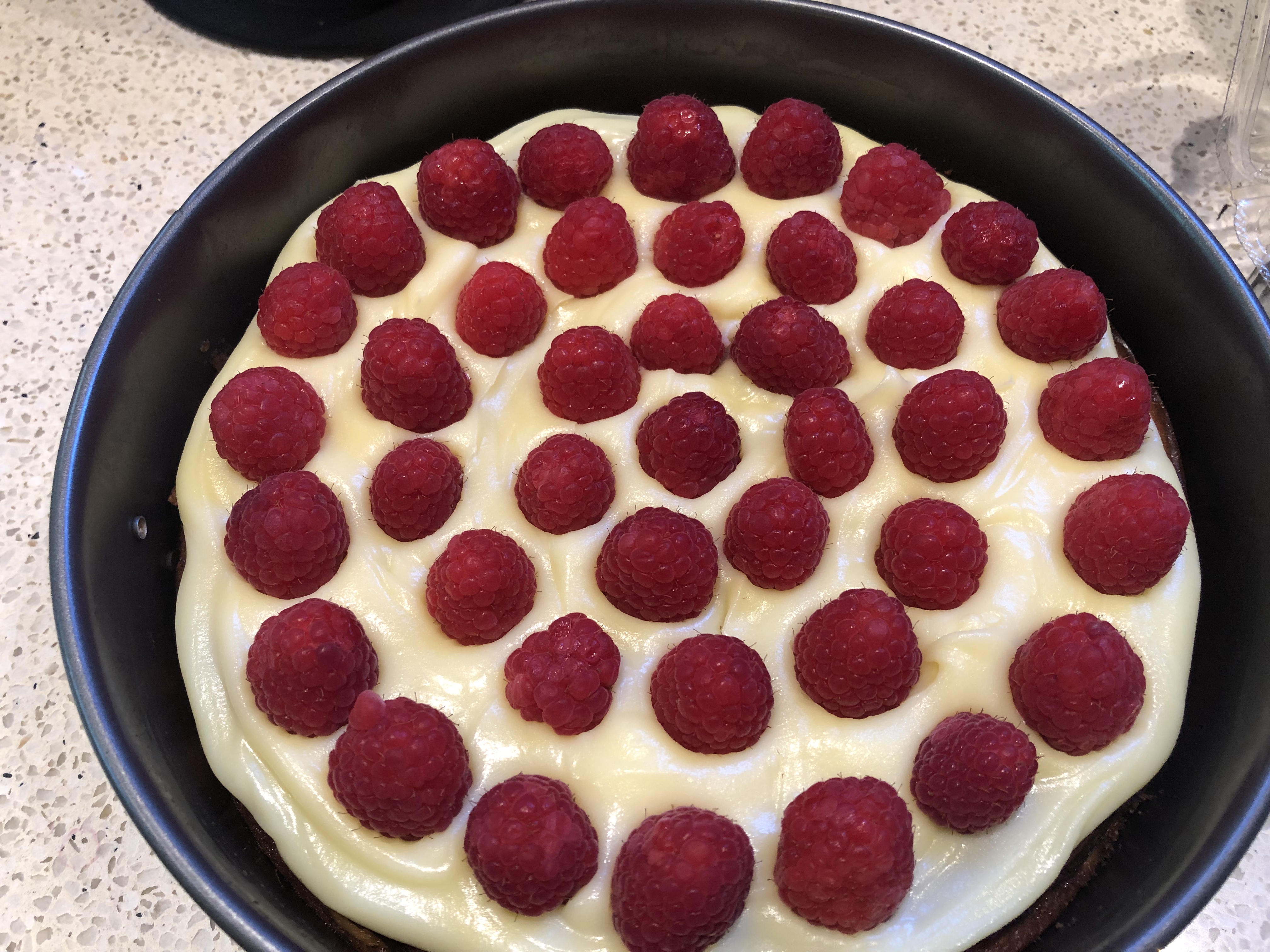 Easy Sour Cream Baked Cheesecake with White Chocolate Ganache and Fresh Raspberries