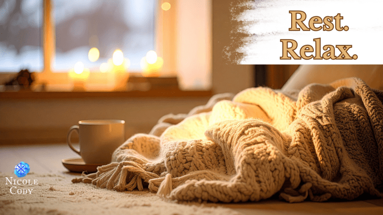 Cosy lounge corner with a blanket and lit candles in warm golden light.