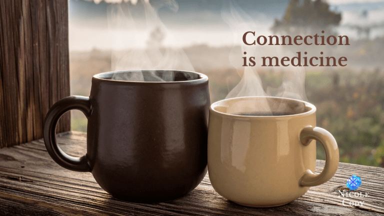Two steaming mugs of coffee on a wooden railing at sunrise, symbolising warmth, connection and simple shared moments